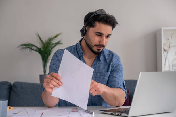 istock handsome young businessman talking online with computer at home 1393201742