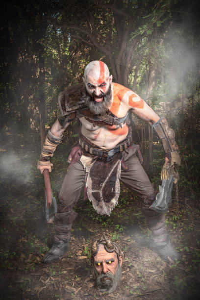 istock COSPLAY SESSION. WARRIOR STANDING WITH SWORD AND AXE. WAR CRY. 1393201874