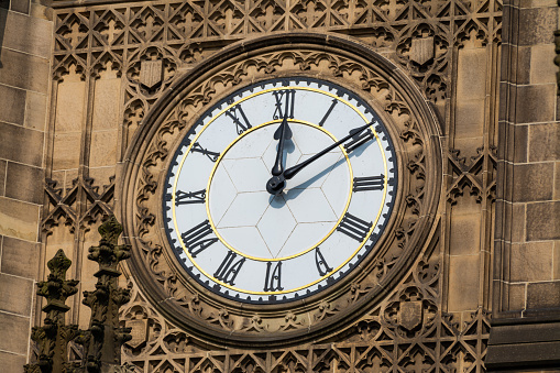 Clock on cathedral tower.  Manchester, England.