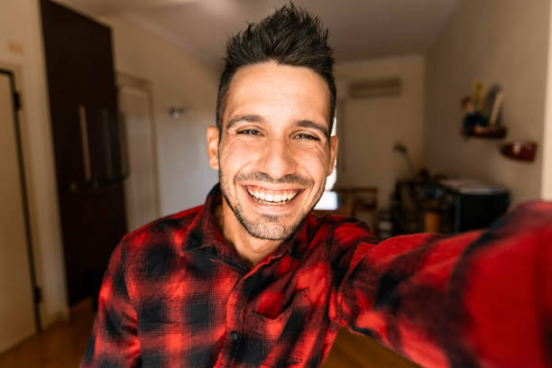 istock Handsome caucasian man taking a self portrait indoor at home 1393207758