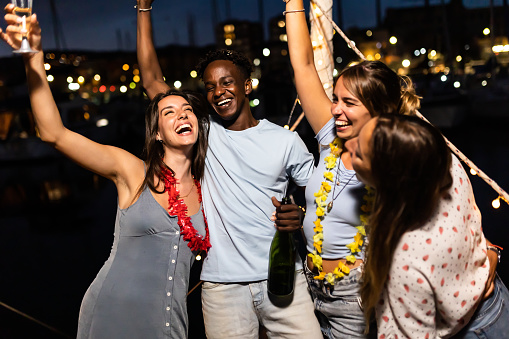 istock Happy young friends celebrating together on boat party in summer vacation 1393210577