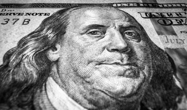 istock Benjamin Franklin portrait on USA dollar bill, one hundred US dollar note close up 1393210670
