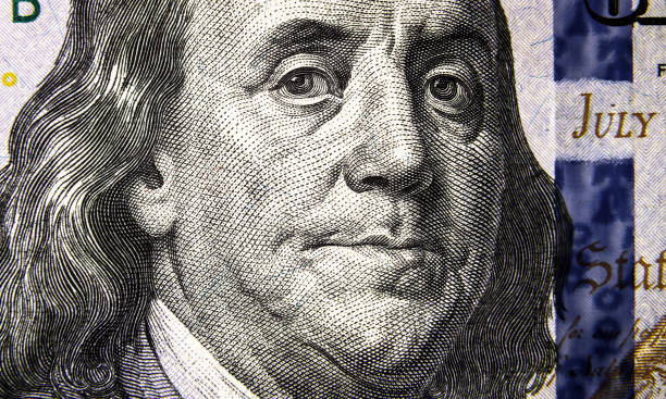 istock Macro view of 100 US dollar bill, Benjamin Franklin portrait 1393210711
