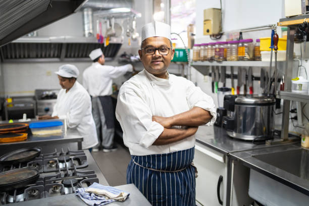A smartly dressed Indian chef looking at the camera stock photo