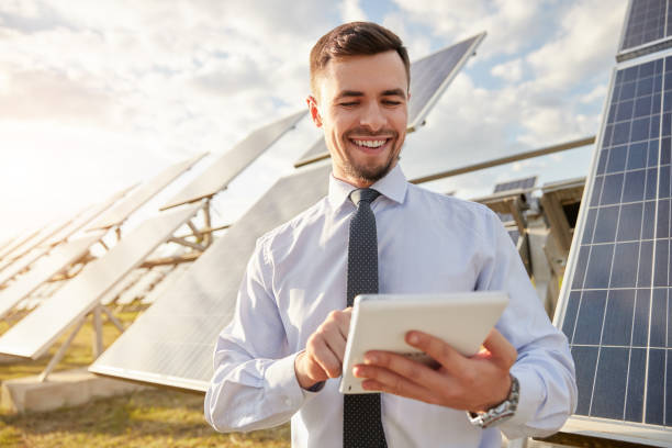 istock Cheerful businessman using tablet on solar farm 1393223636