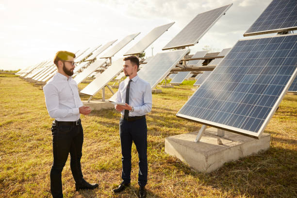 istock Colleagues in formal wear discussing solar power station project 1393223640