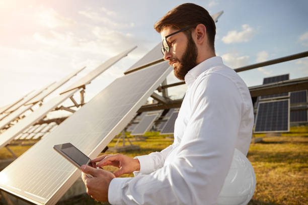 istock Businessman using tablet on solar power station 1393223678