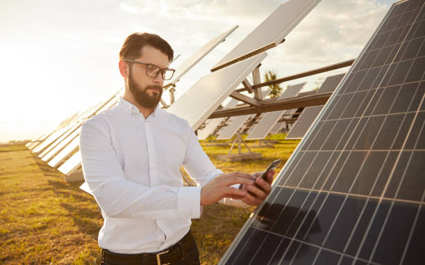 istock Man controlling solar panels via smartphone 1393223681