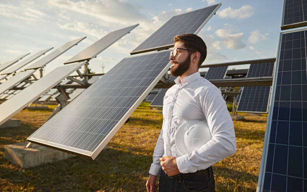 Power station owner near photovoltaic panels stock photo