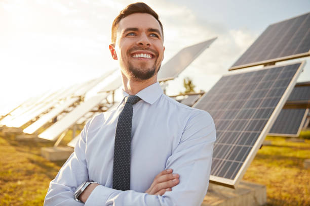 istock Cheerful investor in field with solar batteries 1393223691