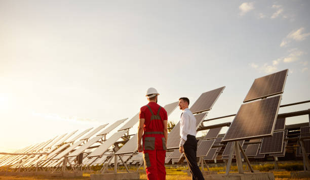 istock Engineer and foreman in field with solar batteries 1393223717