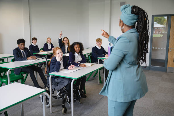 istock Black female educator calling on student with hand raised 1393223796