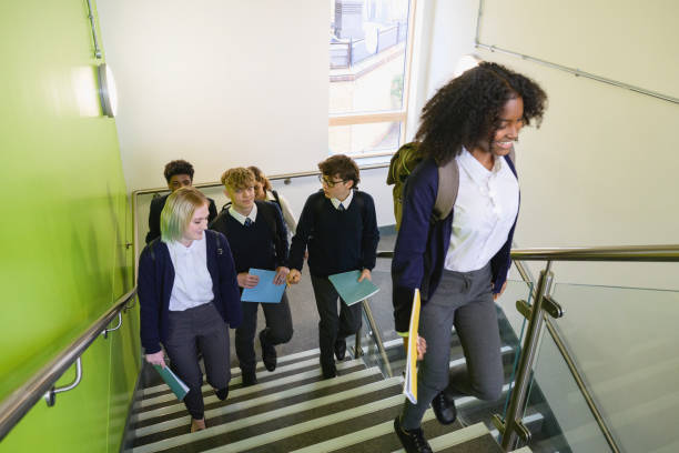 istock Secondary students walking up staircase in school building 1393223797