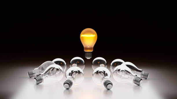 istock One being on light bulb in group of darkened lamp,  leader innovation concept, 3D rendering. 1393224585