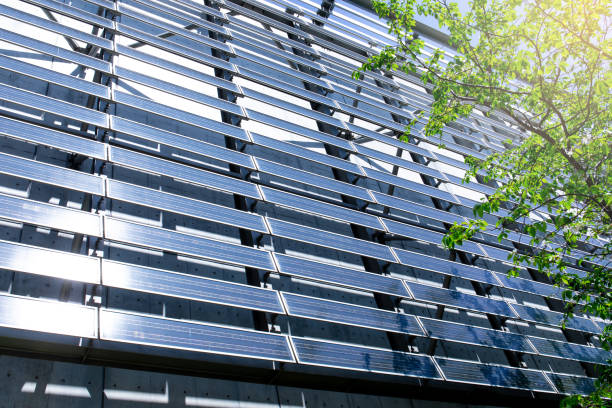 Solar Panel wall on Building Solar Panel wall on Building with tree leaves low carbon economy photos stock pictures, royalty-free photos & images