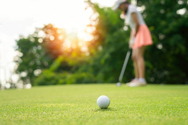 Women driving practice golf or trainer at the golf course on the fairway at sunset Women driving practice golf or trainer at the golf course on the fairway at sunset af_istocker stock pictures, royalty-free photos & images