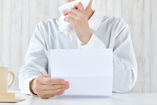 Woman  crying alone while reading letter