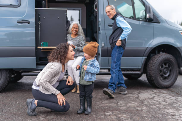 toddler girl and pregnant mom having fun while camping with family - grandmother senior adult child multi generation family imagens e fotografias de stock