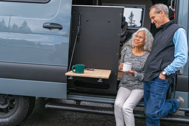 istock Adventurous retired couple enjoying morning coffee outside their camper van 1393230549