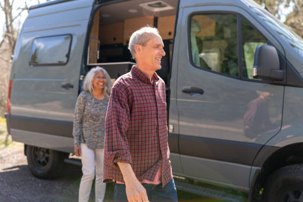istock Retired couple arriving at campsite while traveling in camper van 1393230592