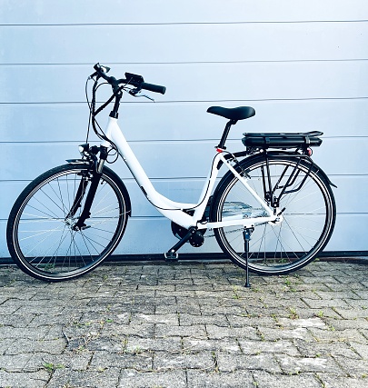 White E-Bike parked on blue background