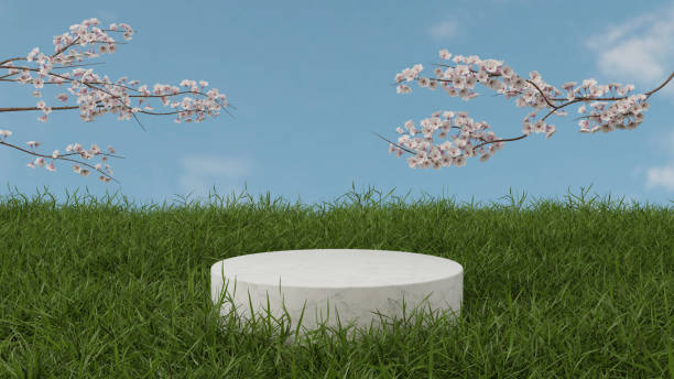 istock Cylindrical marble podium on grass field and cherry blossom 3D render illustration 1393245663