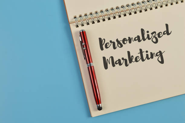 istock Top view of pen and notebook written with PERSONALIZED MARKETING 1393247016