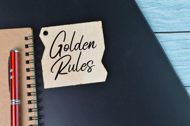 Top view of pen, notebook and label tag written with GOLDEN RULES.