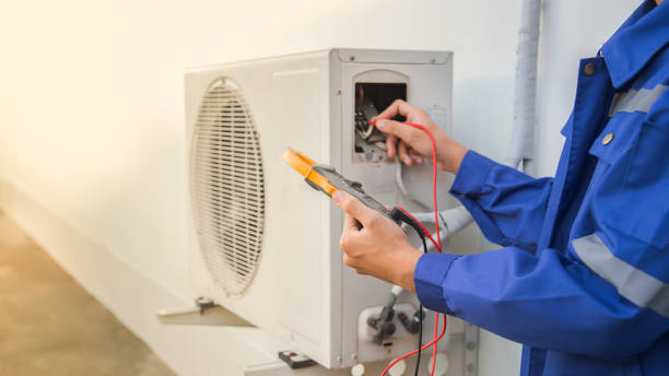 Technician checking the operation of the air conditioner stock photo