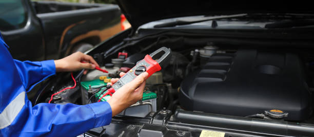 istock Technician checking the electrical system of the car. 1393252828