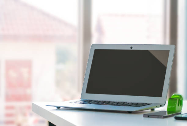 istock Blank Screen Laptop Computer Mock up on office desk for application website template advertisement. 1393254524