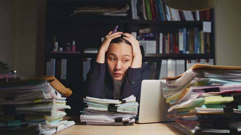 Tired frustrated businesswoman executive working late at night in the office,