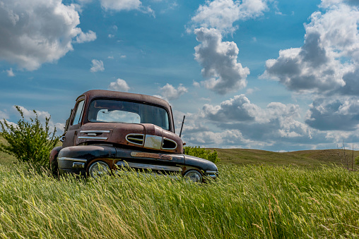 An abandoned truck in tall grass on the Saskatchewan prairies