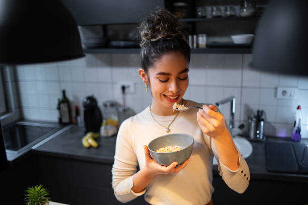 istock A young woman eats oatmeal 1393258753