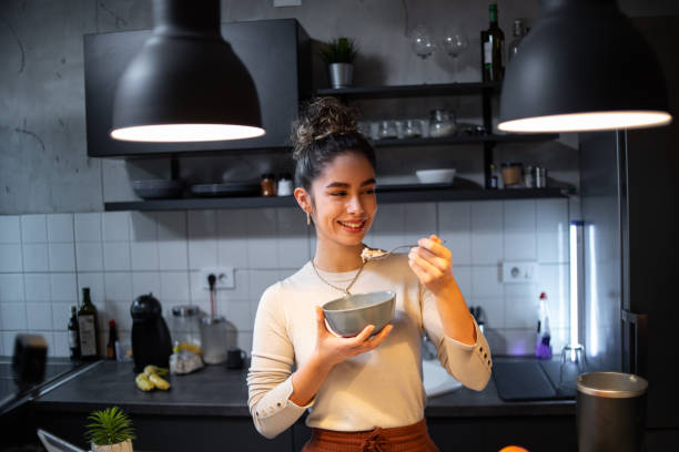 istock A young woman eats oatmeal 1393258754