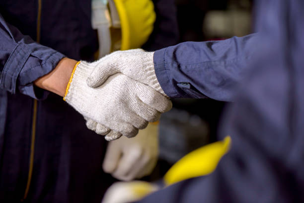team of engineer mechanic man get handshake together stock photo