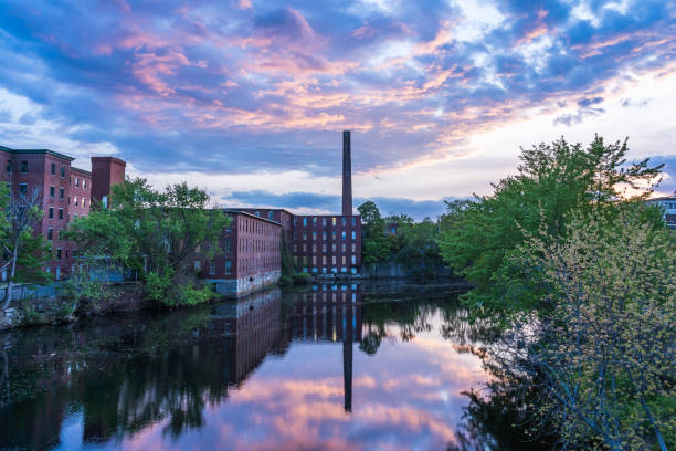 istock Historic cotton mill building with a tall brick chimney 1393261990