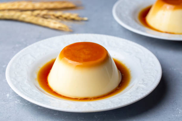 istock Cream caramel pudding with caramel sauce in plate on white rustic table 1393264494
