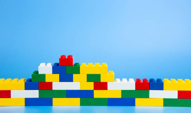 istock Color plastic building blocks on blue background 1393266291