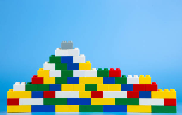 Plastic building blocks on blue background