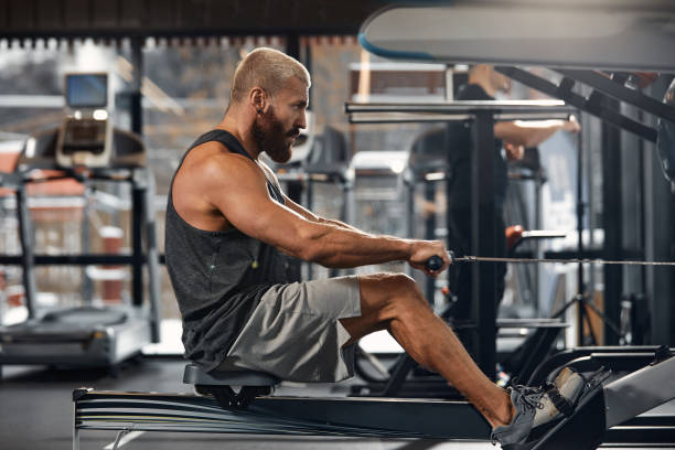 istock Training legs in the simulator, the athlete works with his legs on the simulator, working out the muscles on the legs 1393267988