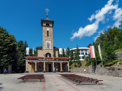 Szczyrk, Poland: August 10, 2021 - Sanctuary of Our Lady, Queen of Poland, Pilgrims believe that here the Virgin Mary appeared in a brick chapel with a view of the mountains.