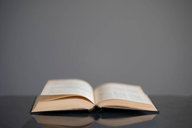 istock opened old book on the table as the symbol of wisdom and knowledge, education concept 1393270905
