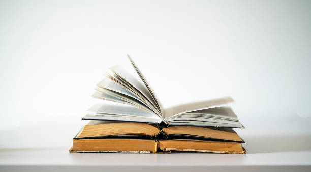 istock opened old book on the table as the symbol of wisdom and knowledge, education concept 1393270908