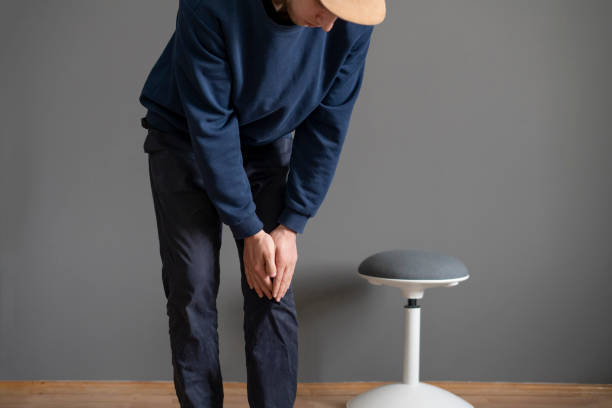 istock man touch his ankle, feeling pain and stress 1393270987