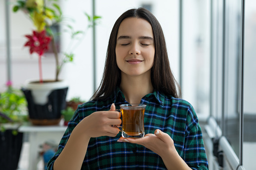 Woman having a tea at home
