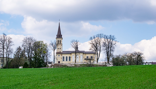 a church with a pointed tower on the hill