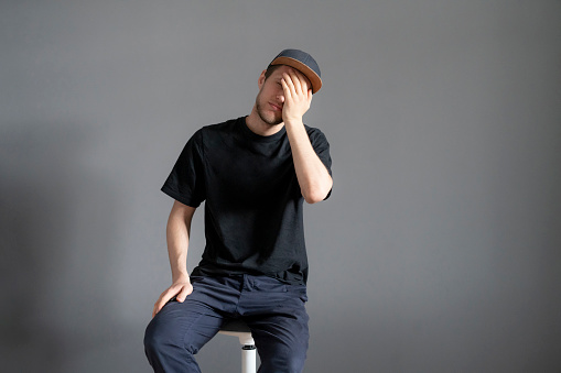 young male cover his face with hand, shame and disappointment concept, facepalm emotion