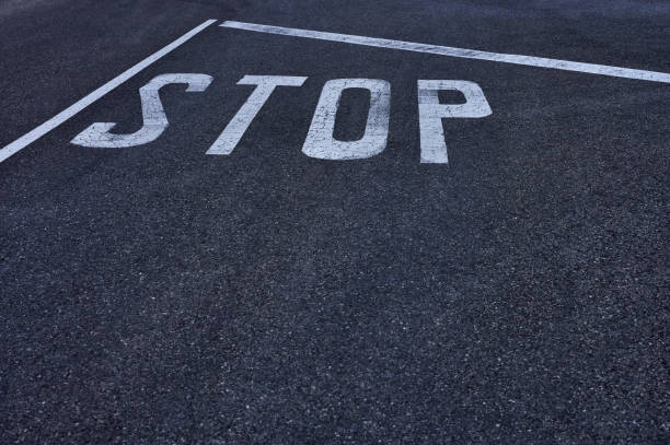 istock white stop sign painted on the pavement 1393274953