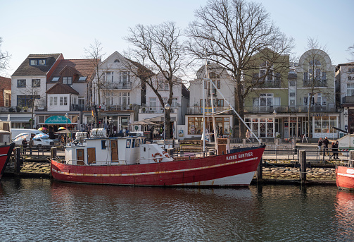 Warnemünde, Rostock, Germany - March 3, 2022: Old fishing boats on the Alter Strom in Warnemünde Rostock in spring.
